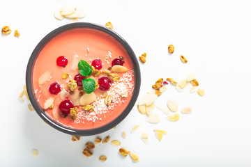 Healthy food by color of 2019 living coral Yogurt Breakfast Bowl  with coconut, almond, flax seeds, Granola, and red currants in ceramic bowl with copy space