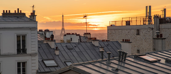 The Eiffel Tower and the rooftops of Paris seen from Montmartre with a sunset