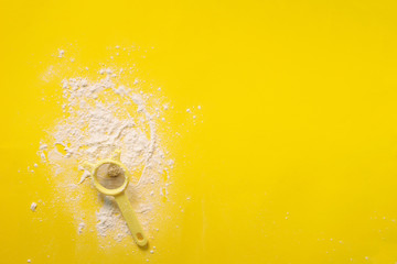 Flour sieve on yellow background. Baking and cooking concept. Banner with copy space.