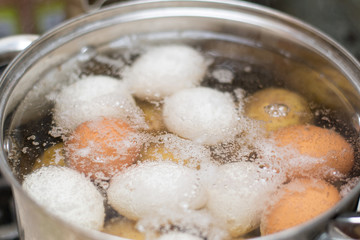 Boiling chicken eggs in the pan.