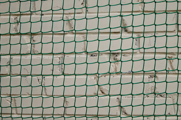 Grid with green cells on a white wall