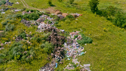 Fototapeta na wymiar Aerial view of the garbage dump on the meadow. Pollution of the planet.