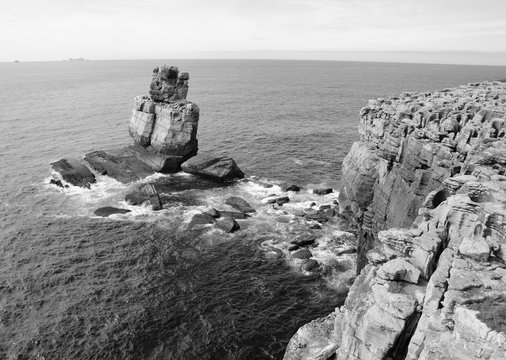 Beautiful rocks in water. Atlantic ocean coast near Peniche (Portugal). Black and white photo