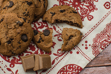 freshly baked chocolate chip cookies on rustic wooden table