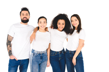 Fototapeta premium multicultural friends smiling and hugging while looking at camera isolated on white