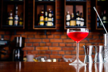 cosmopolitan cocktail in margagita glass closeup on bar counter with copy space