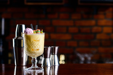 yellow cocktail on bar background, night club scenery