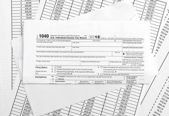 Folded tax form with envelope on financial documents.
