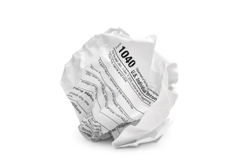 Crumpled sheet of tax form on white.