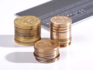Credit card and coins on white background