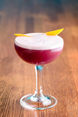 Red Boulevardier Cocktail or Manhattan cocktail drink decorated on bar counter in pub or restaurant