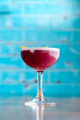 Red Boulevardier Cocktail or Manhattan cocktail drink decorated on bar counter in pub or restaurant