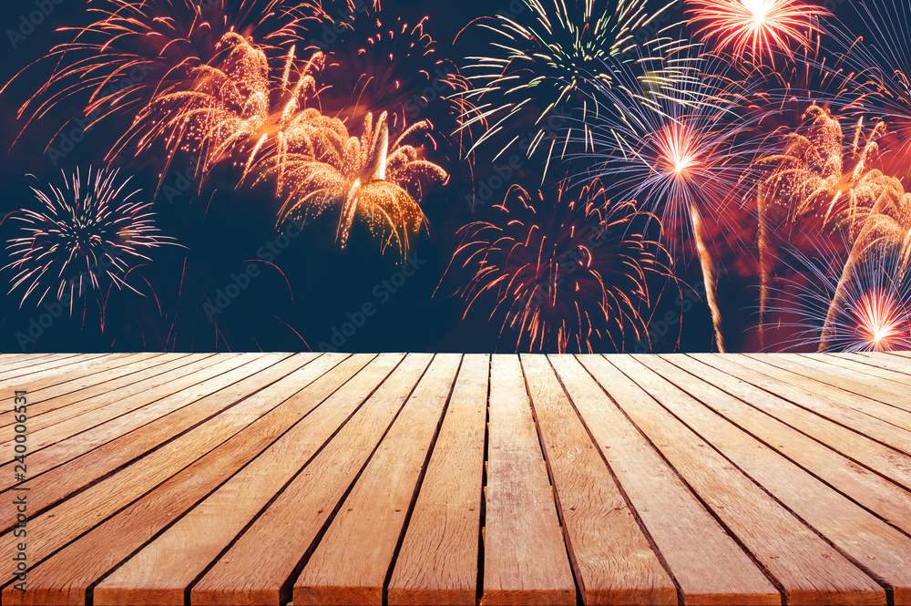 Wall mural fireworks abstract background for celebration with wooden table top for advertise