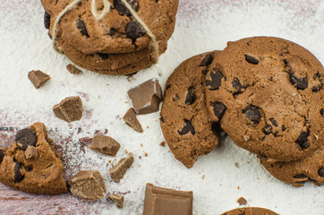 freshly baked chocolate chip cookies on rustic wooden table