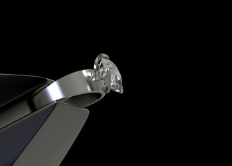 3d rendering. perspective view of steel stick tonging pure diamond ring with clipping path isolated on black copy space background.
