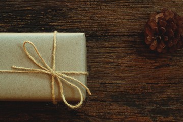 Simple eco friendly gift boxes package wrap with brown paper in old wooden table background, green present concept