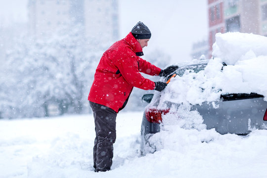 Man Cleaning Frozen Car Covered Snow At Winter Day,.