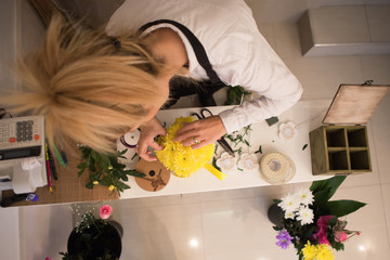 The yellow, beautiful floral arrangement is almost completed.