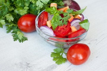 Healthy cooking of salad with fresh delicious ingredients making on cutting board. Diet or vegetarian food concept.
