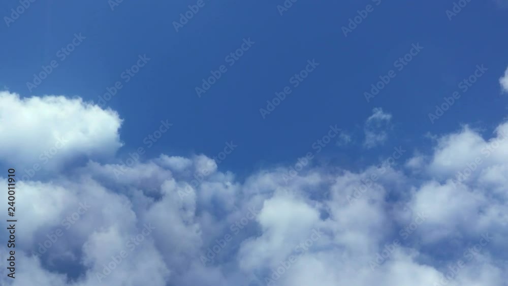 Wall mural flying in the clouds, camera movement through the clouds, video loop