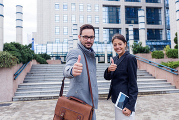 Successful business team showing thumb up