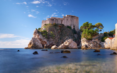 Fototapeta na wymiar Fort Lovrijenac in Dubrovnic as seen from the beach. Long exposure to create flat water on a clear bright sunny day. 