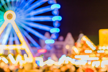 Bright blue Ferris wheel at the Christmas fair. Defocused xmas abstract. Blurred background