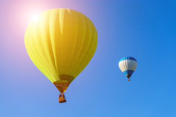 two hot air  balloons in the blue sky