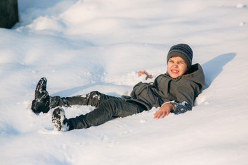 Fototapeta na wymiar Little boy in snow. Winter weather. Holiday. Christmas