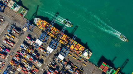 Container ship in export and import business logistics and transportation. Cargo and container box shipping to harbor by crane. Water transport International. Aerial view and top view.