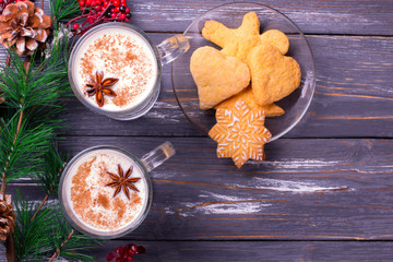 Christmas eggnog in glass mug and cinnamon.