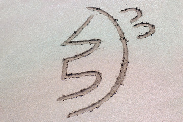 Reiki healing symbol sei he ki on sand.