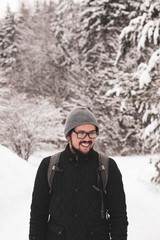 Fototapeta na wymiar Smiling man in a winter forest 