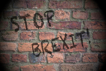 Stop Brexit written on a brick wall.  Brexit concept with lighting effect