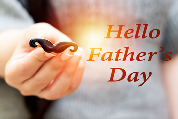 woman holding mustache ring, happy father's day concept