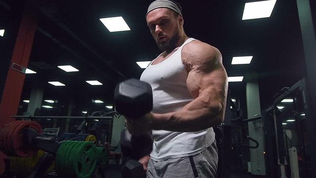 Brutal strong athletic men pumping up muscles workout bodybuilding sport nutrition concept background - muscular bodybuilder handsome men doing exercises in gym naked torso
