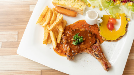 Pork Chop steak on a white plate.
