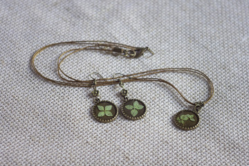 Fototapeta na wymiar Necklace with a pendant and earrings. Imitation jewelry