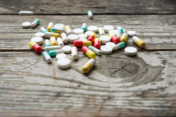 Drugs in medical container. Box on wooden background.