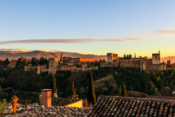 Obraz premium Alhambra Palace in Granada, Andalucia, Spain. Sierra Nevada mountains at the background. Golden hour at sunset.