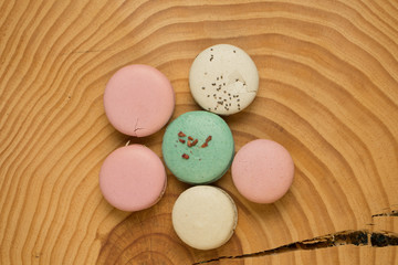 Obraz na płótnie Canvas Colorful French or Italian macaron on the wood table with copy space for background. Macarons or macaroons is French dessert