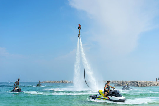 Man posing at new flyboard at Caribbean tropical beach. Positive human emotions, feelings, joy. Funny cute men making vacations and enjoying summer.