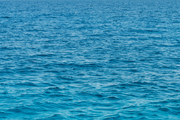 Blue sea background. Blue sea surface with waves.