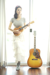 Beautiful girl playing ukulele