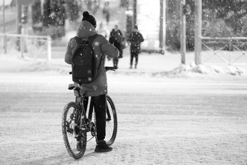 cyclist on a bike in winter on the street