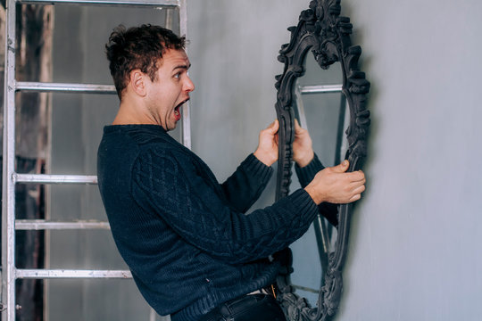 The man looked at his reflection in the mirror and was scared