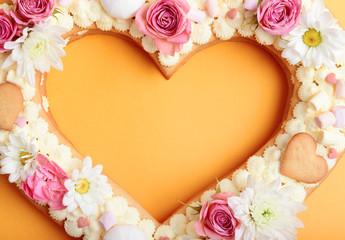 Valentine's Day heart-shaped cake with flowers as decoration. The concept of a gift to a loved one on a holiday.