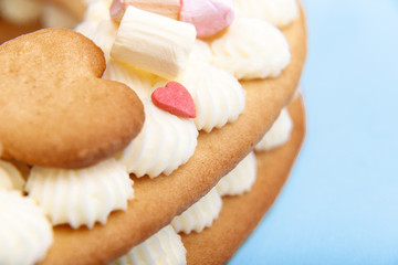 Valentine's Day heart-shaped cake with flowers as decoration. The concept of a gift to a loved one on a holiday.