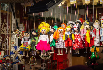 Obraz na płótnie Canvas Wooden colourful toys and dolls at the traditional Christmas market in Prague, selective focus