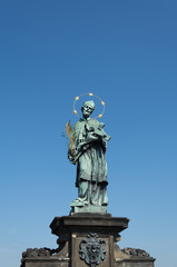 Sculpture at Charles Bridge on Vltava river in Prague, Czech Republi